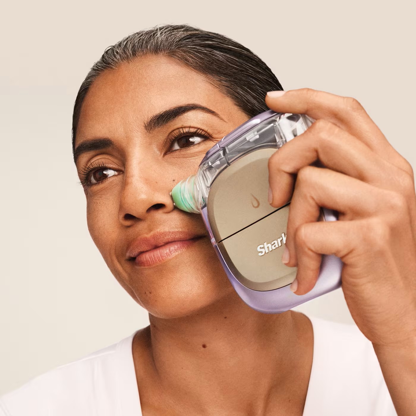 Woman using the Shark FacialPro Glow at-home facial system